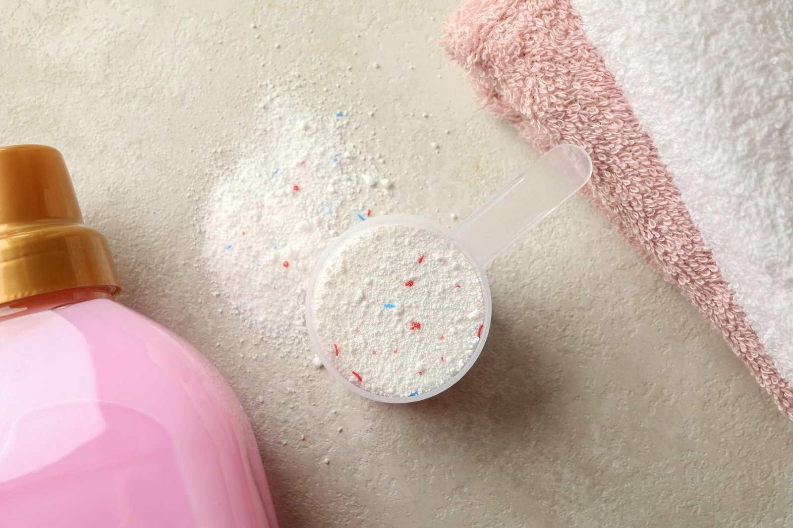 Towels, laundry liquid and scoop with powder