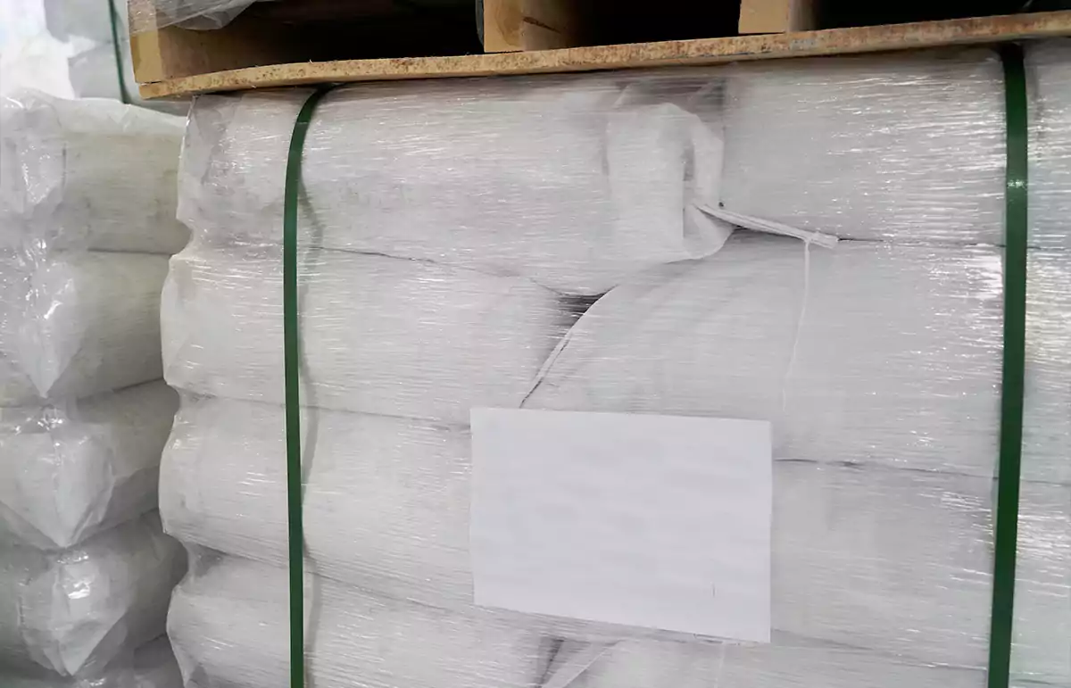 On the pallet are packed white custom product packaging bags.