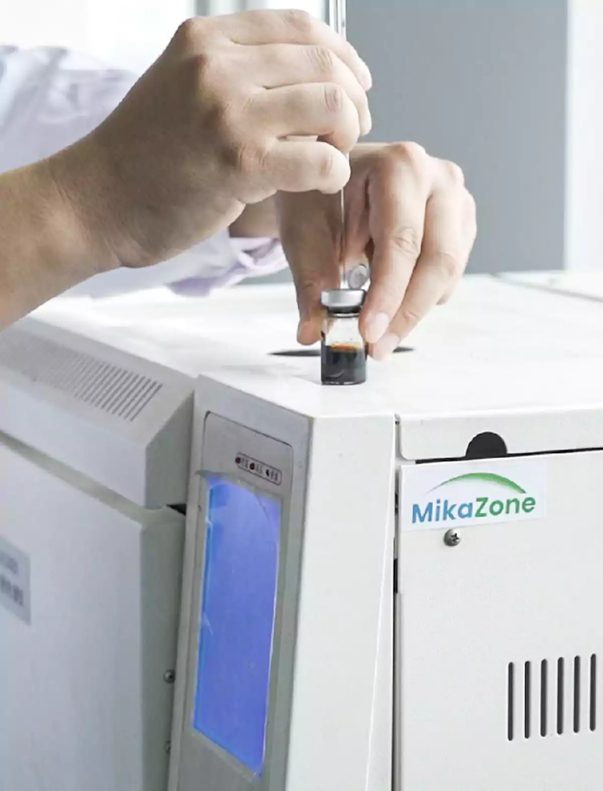 Mikazone lab staff use a syringe to extract liquid for group content testing.