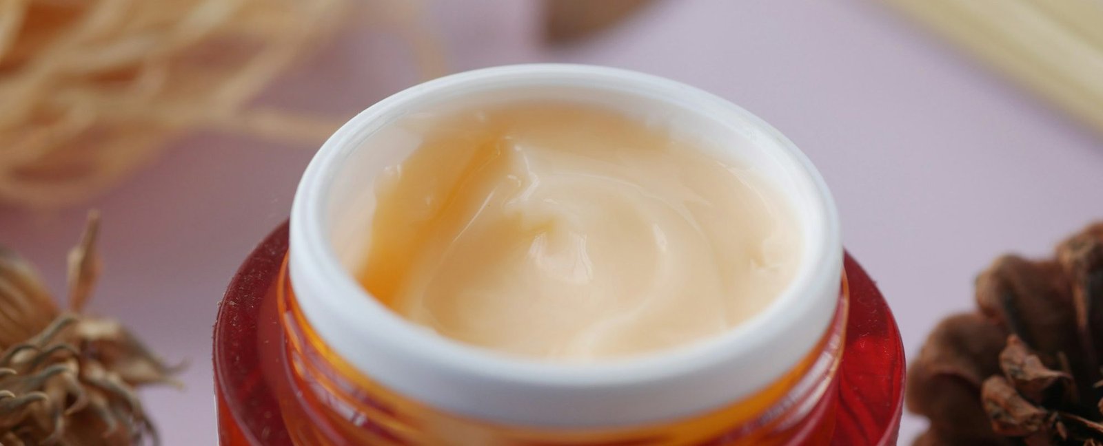 herbal cream cosmetic in a container on table,